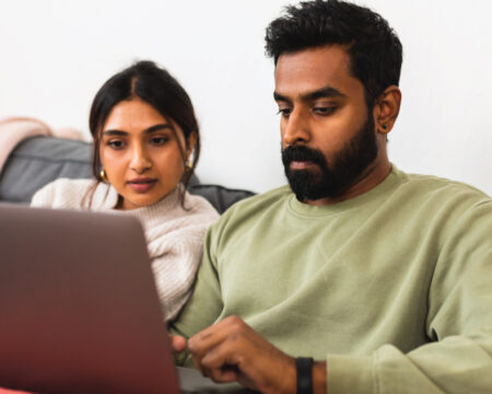 man and woman sitting on the couch with a laptop - how to create a will