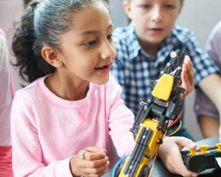 kids in class experimenting with robot