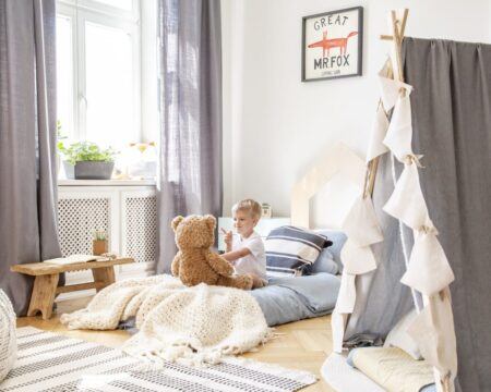 child laying on a montessori floor bed