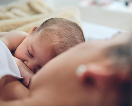 new born baby being embraced by her mom