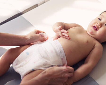 parent changing babys diaper