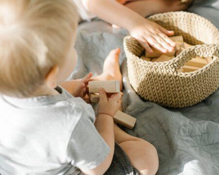 toddler playing with wooden toys -benefits of montessori education