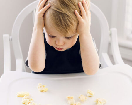 toddler overwhelmed by food in high chair