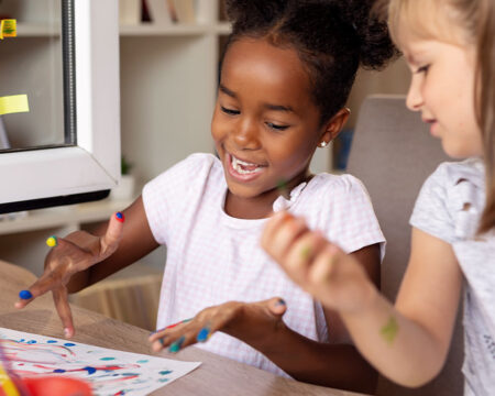 two girls finger painting