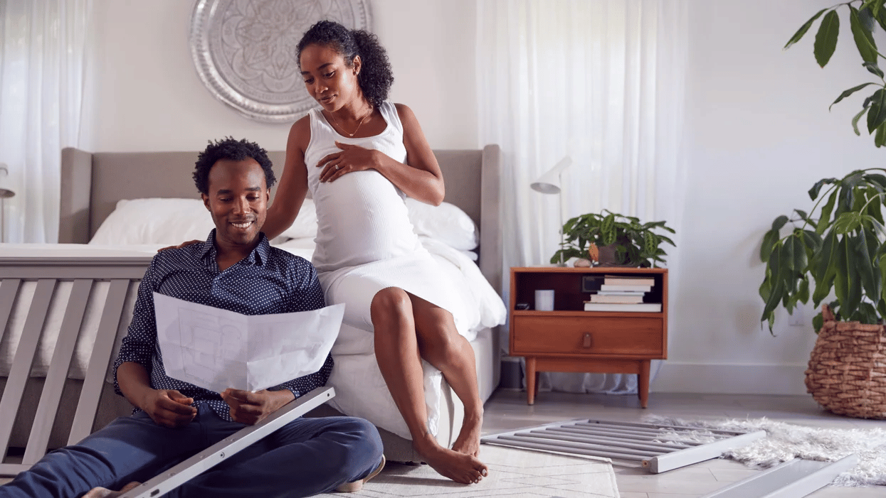 man and pregnant woman putting furniture together