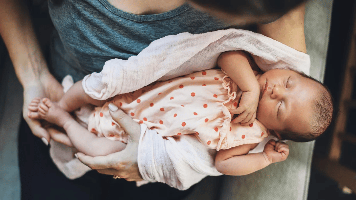 mom holding sleeping newborn