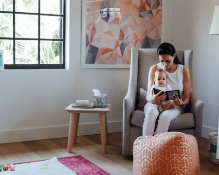 mom reading to baby in nursery